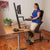 UpmostOffice.com HealthPostures 5100 Stance Angle Sit-Stand Chair, Black, standing model from an angle