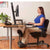 UpliftOffice.com HealthPostures 5100 Stance Angle Sit-Stand Chair, Black, sitting w/ model